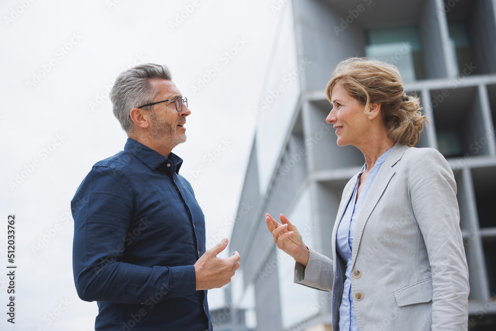 Businessman discussing with businesswoman Businessman discussing with businesswoman