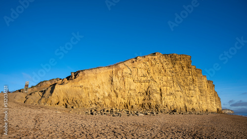 UK, England, West Bay, Sandy beach and sandstone cliffalong Jurassic Coast photo