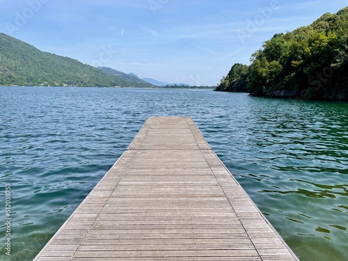 Wooden pier at lake Mergozzo, upper Italian lakes, Piedmont, Italy.
