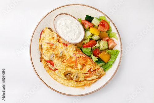 Omelette with ham and salad on a white background