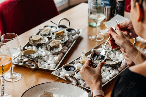 Fresh oysters with lemon. raw opened oyster, lifestyle food, ready to eat. Oyster dinner with champagne in restaurant