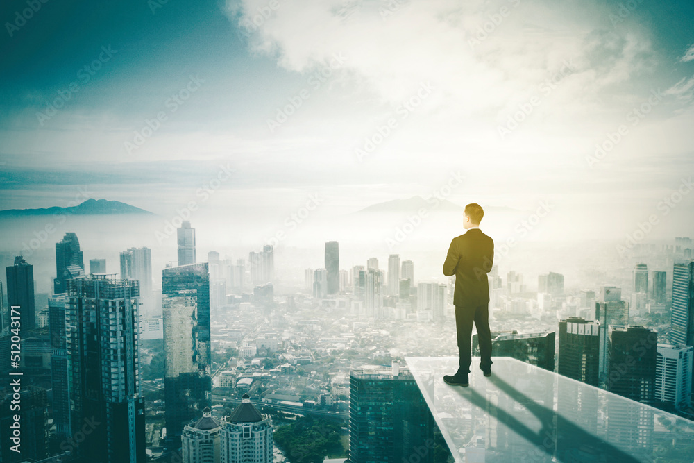 Confident male manager looking at misty city Confident male manager looking at misty city