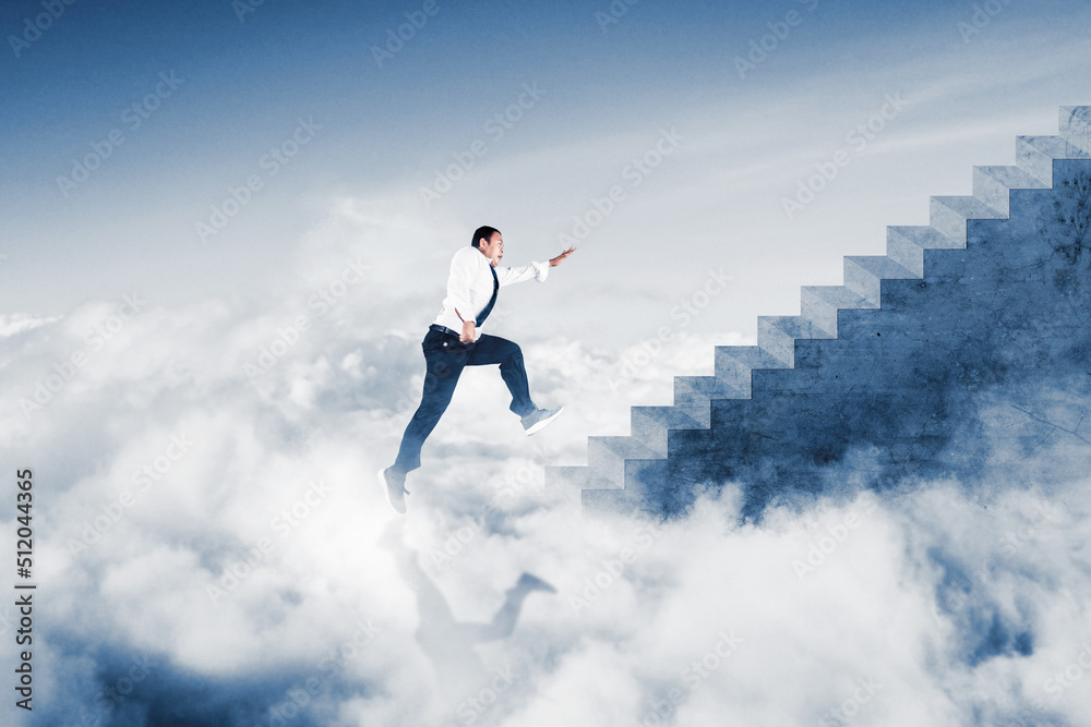 Businessman running on the stairs above the clouds