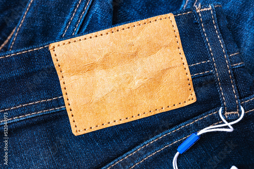 Obraz na plátne Blank leather jeans label sewed on a navy-blue classic jeans.