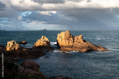 Beautiful rocks on shore of Ploumanac’h in warm sunset.