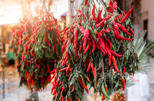 Bari, Puglia, Italy. August 2021. In the historic center, the old bari, a sales counter of the typical local chili pepper. Close up shot on bunch of chillies.