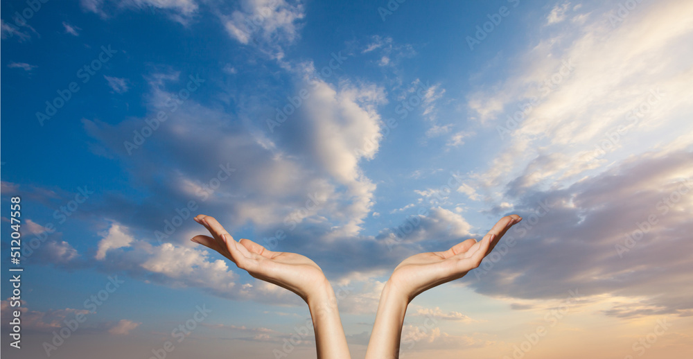 Hands on blue sky clouds background. Power of hope or love and devotion Hands on blue sky clouds background. Power of hope or love and devotion