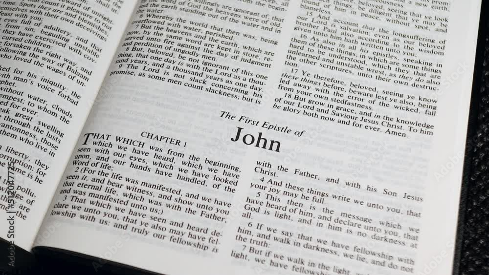 Close Up Shot of Bible Page Turning to the book of First John Close Up Shot of Bible Page Turning to the book of First John