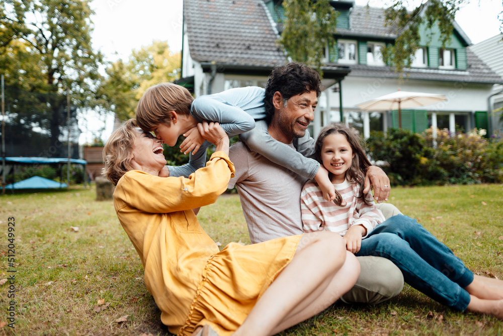Happy family enjoying in front of house Happy family enjoying in front of house