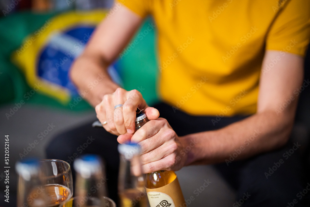 Hands of man opening beer bottle Hands of man opening beer bottle