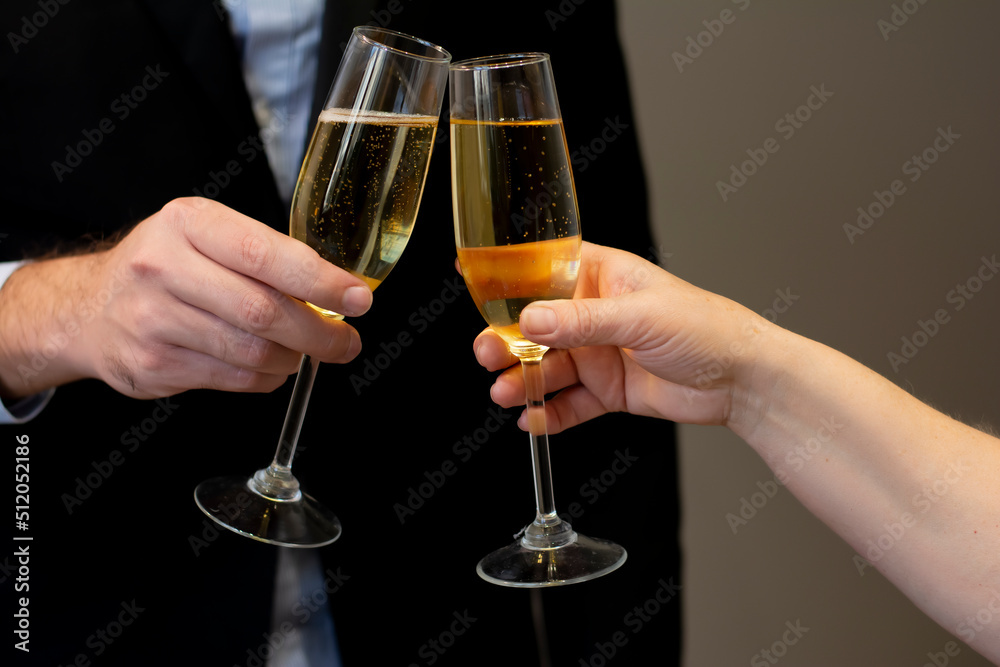 Celebrating with bubbly glasses of champagne of man holding wineglass with champagne