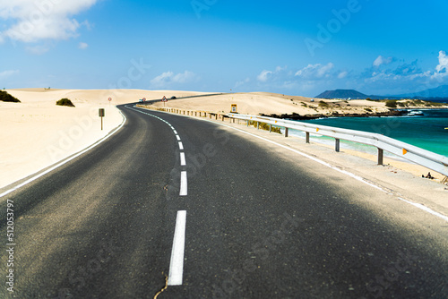 Empty asphalt road crossing the desert, Corralejo Natural Park, Fuerteventura, Canary Islands, Atlantic photo