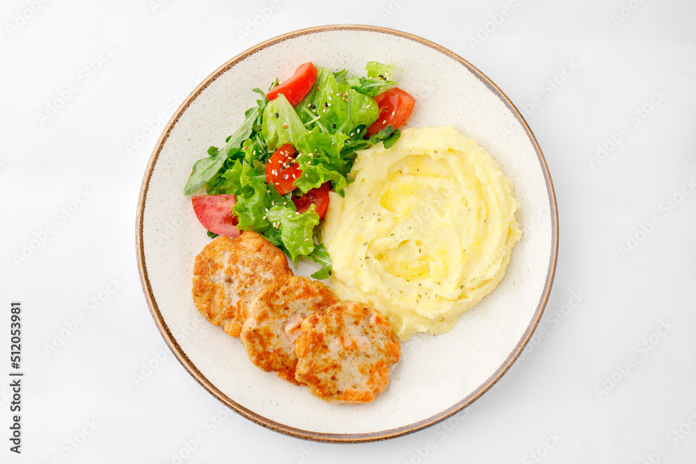 Mashed potatoes with chicken and salad on a white background