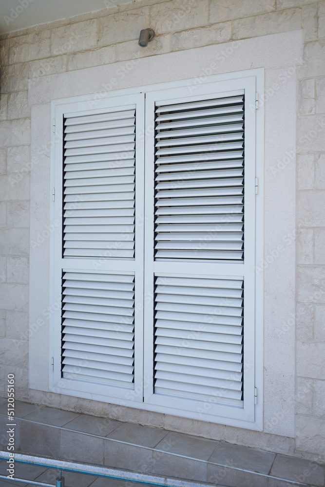 External window shutters on a residential building External window shutters on a residential building
