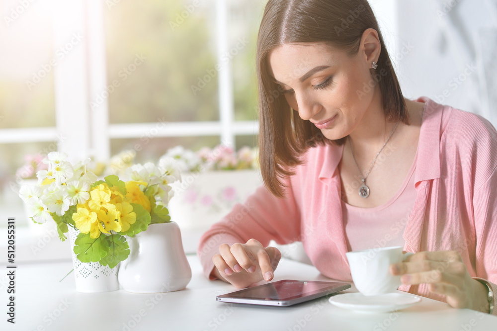 Beautiful woman drink tea and using smartphone Beautiful woman drink tea and using smartphone