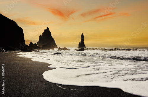 Silhouetted offshore rocks along the coast at Reynisfjara, near Vik, south coast of Iceland photo