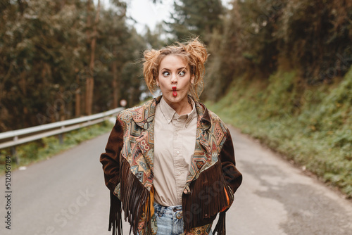 Red-haired girl with bows and jacket in the middle of the road