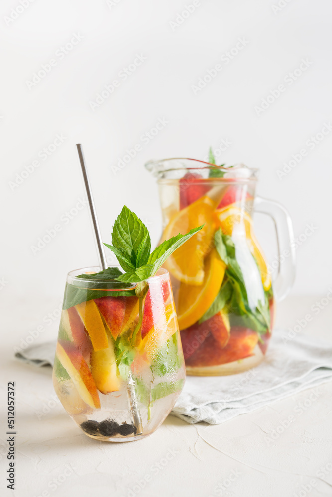 Freshness peach lemonade in glass garnish mint on light background. Summer healthy drink. Vertical. Freshness peach lemonade in glass garnish mint on light background. Summer healthy drink. Vertical.