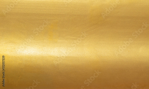 Gold texture background with yellow metallic foil luxury shiny shine glitter sparkle of bright light reflection. Metal bronze golden surface, celebration, banner, wallpaper, design. Gold horizontal