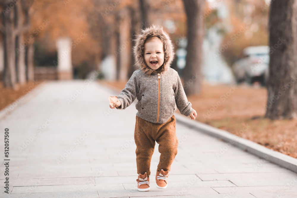 Cute baby girl 12 year old wear jacket with hood and pants walk in