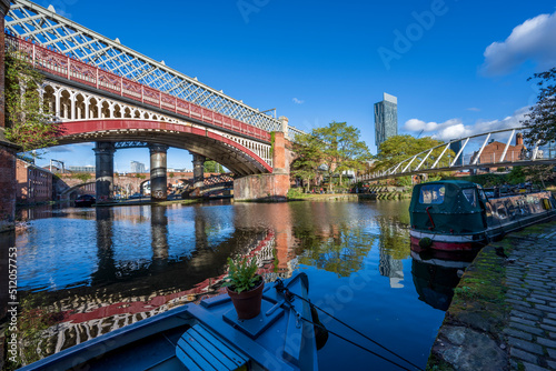 Railway, footbridge and canal boat moored at Castlefield, Manchester, Lancashire, England photo