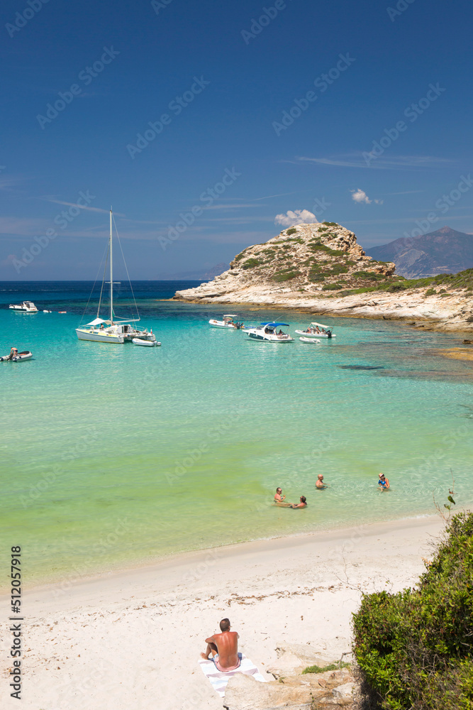 Tourists relaxing in shallow turquoise water off the Plage du Petit Loto, St-Florent, Haute-Corse Tourists relaxing in shallow turquoise water off the Plage du Petit Loto, St-Florent, Haute-Corse