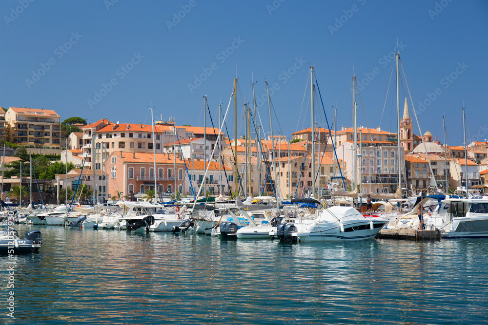 View across marina to the town, yachts and motor boats reflected in tranquil water, Calvi, Haute-Corse View across marina to the town, yachts and motor boats reflected in tranquil water, Calvi, Haute-Corse
