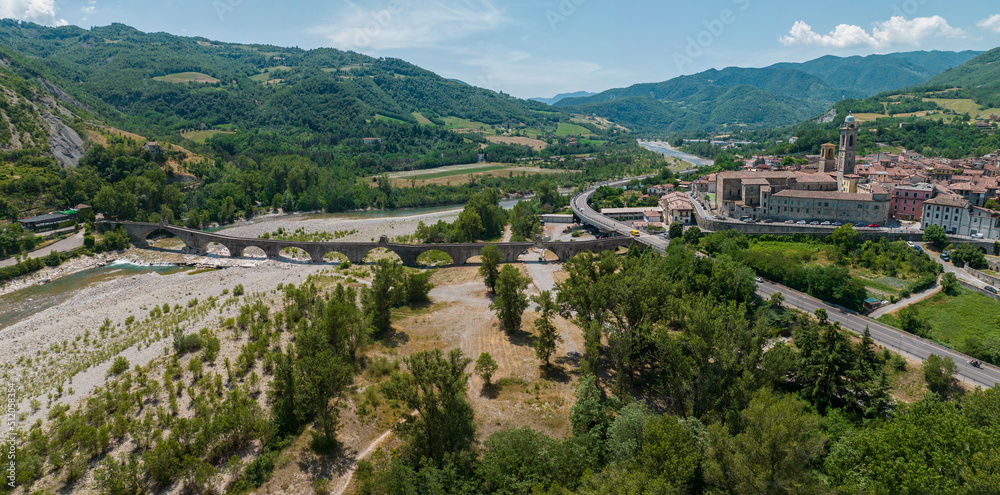 Aerial view of Bobbio, a town on the Trebbia river. Bridge. Piacenza, Emilia-Romagna. Details of the urban complex, roofs and bell towers of the town between the valleys of the Apennines. Italy. Droug
