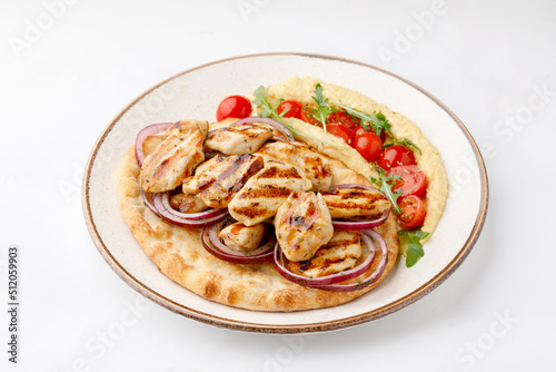 Chicken grilled with pita and salad on white background