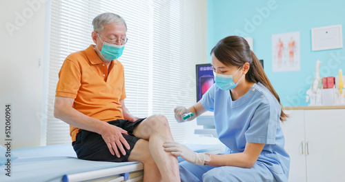 doctor examining patient knee