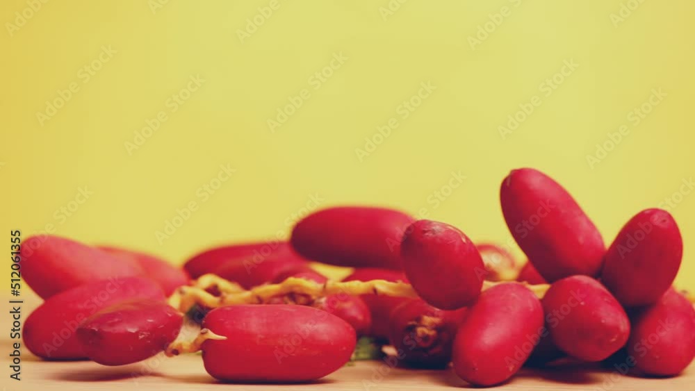Close up view of rotating raw dates in wooden bowl with selective, close up view red dates Close up view of rotating raw dates in wooden bowl with selective, close up view red dates