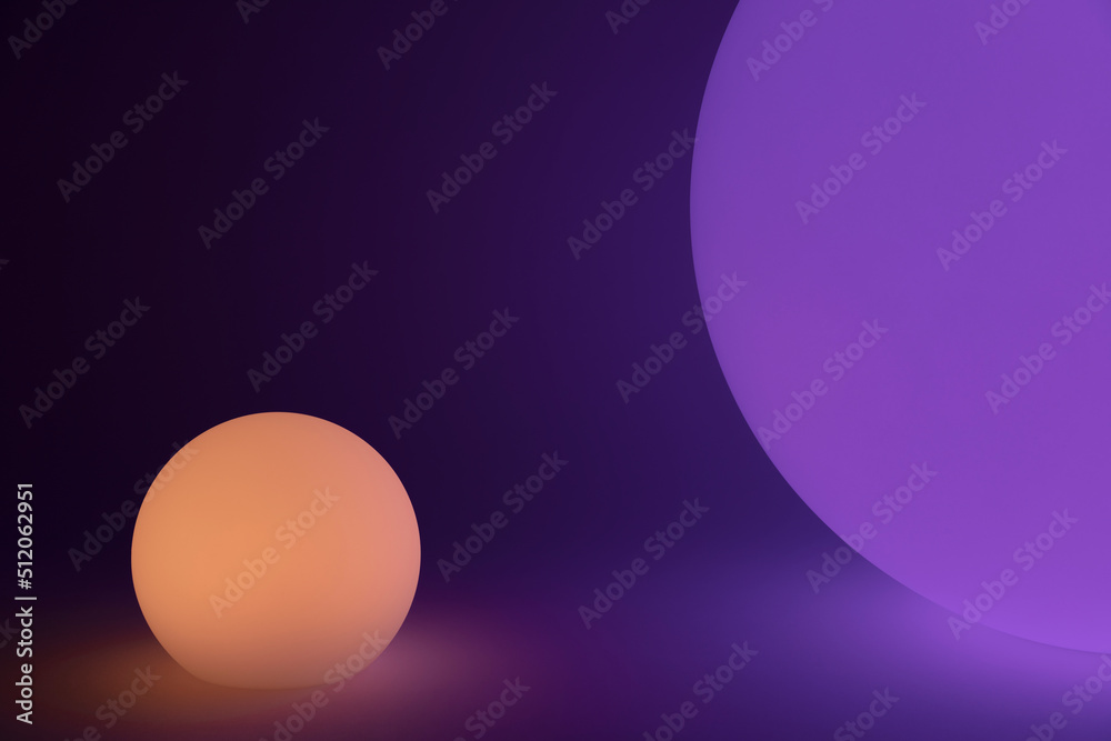 Glowing and illuminated spherical orbs, one large and one small.