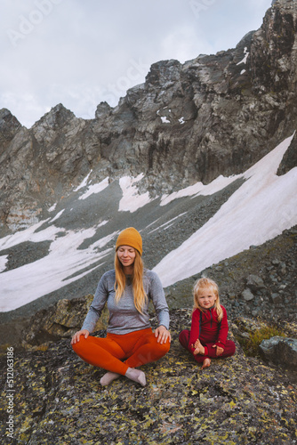 Family mother and daughter outdoor practicing yoga in mountains healthy lifestyle vacations parent and child training together harmony with nature meditation