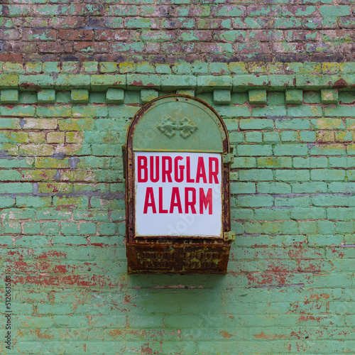 Old burglar alarm ona  building facade photo
