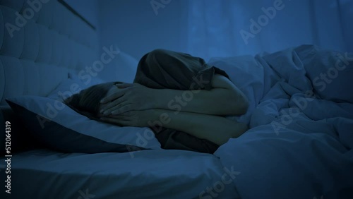 Depressed woman feels emptiness lying in bed at late night