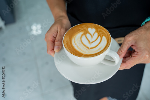 hot latte art coffee on hand table, relax time