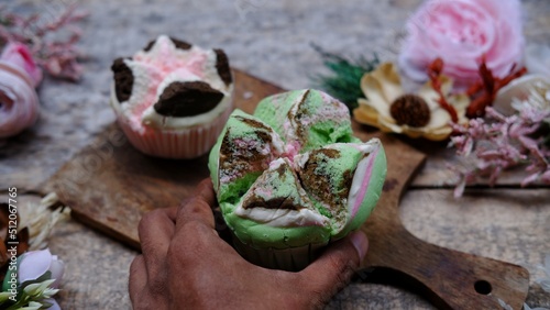 Bolu kukus mawar, Indonesian steamed cake on wooden background photo