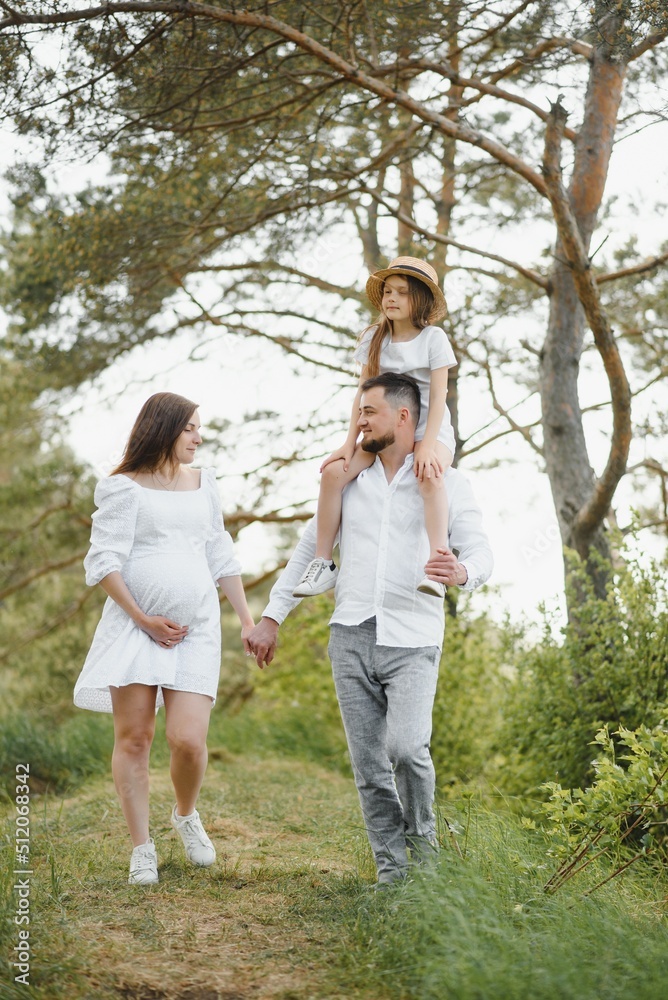 Pregnant woman with her family looking happy Pregnant woman with her family looking happy