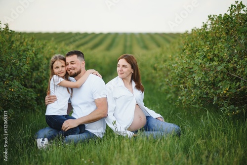 Pregnant woman with her family looking happy