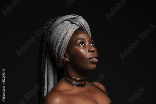 Fotografija Shirtless black woman wearing headscarf looking downward