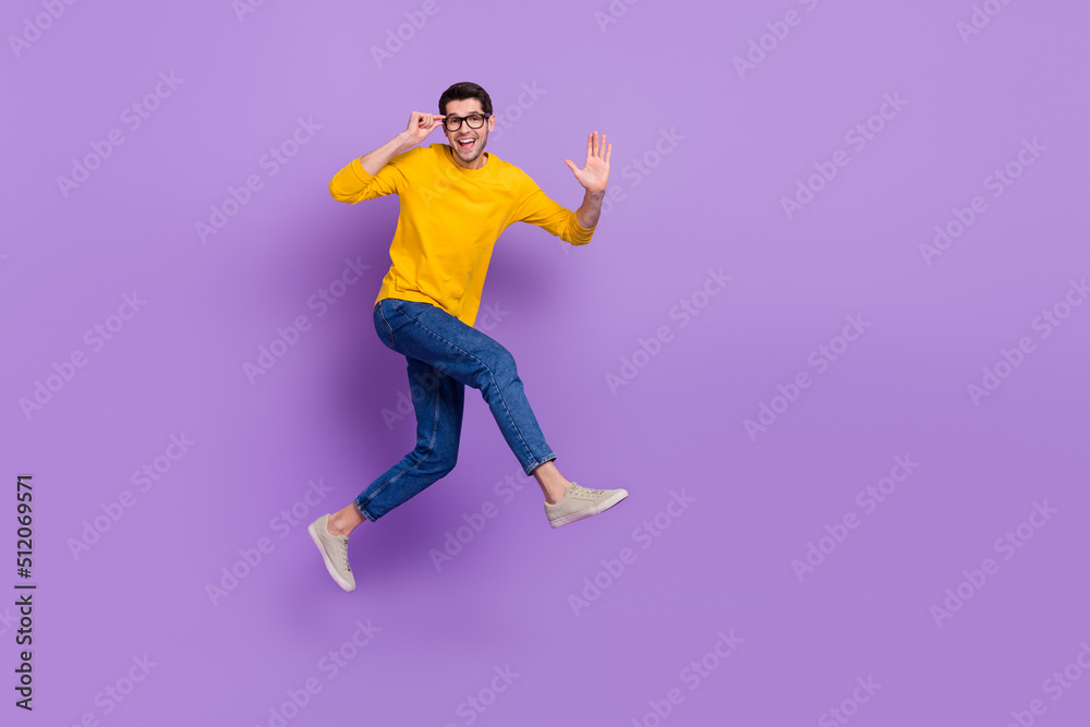 Full length profile side image of overjoyed carefree man running go on vacation isolated on violet color background