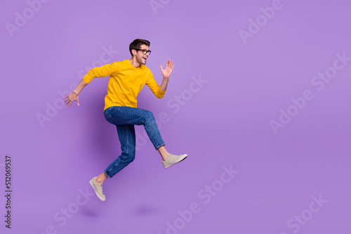 Full length image of overjoyed delighted man running fast speed traveling have fun isolated on violet color background