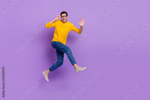 Fototapeta Naklejka Na Ścianę i Meble -  Full length profile side image of overjoyed carefree man running go on vacation isolated on violet color background