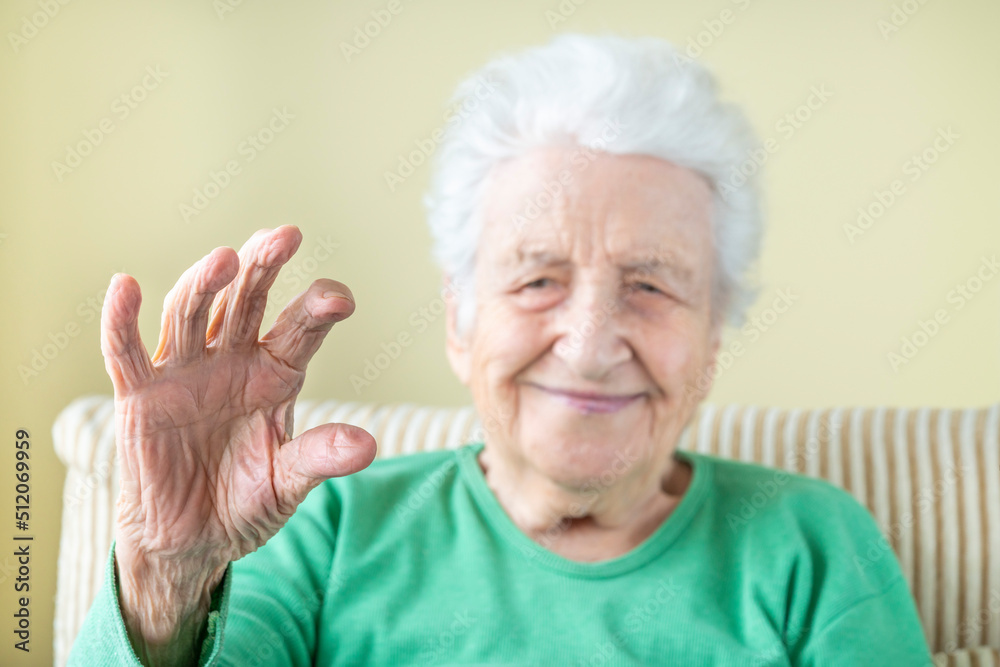 closeup wrinkled hand of a senior woman as if holding something between fingers closeup wrinkled hand of a senior woman as if holding something between fingers