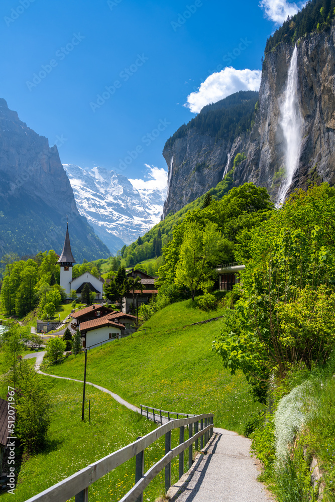amazing alpine landscape in Lauterbrunnen village with church and waterfall in Switzerland