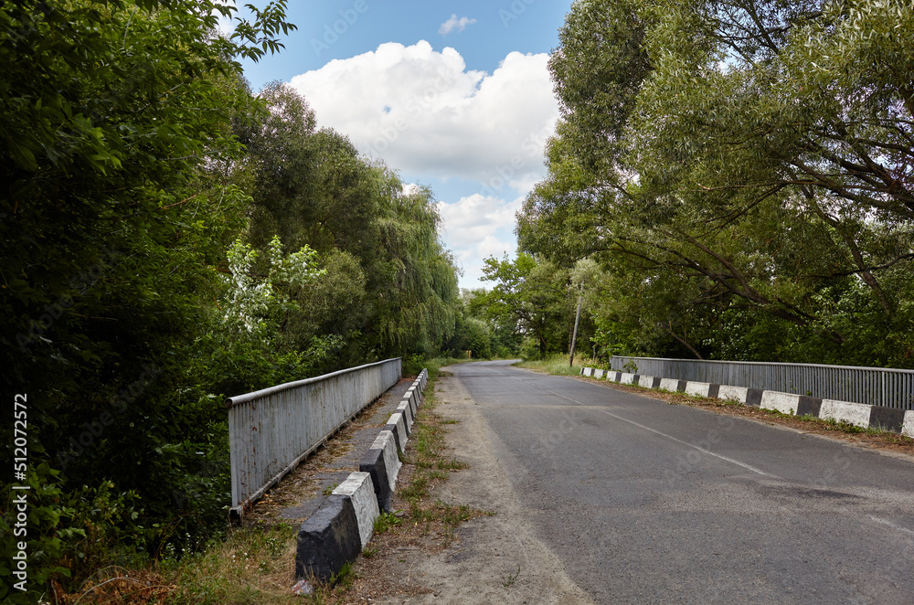 Fototapeta premium Barrier, designed to prevent the exit of the vehicle from the curb or bridge. Guarding rail on suburban road