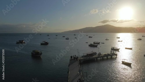 Small Vessels and Boats in Zimbros Beach Bay, Aerial Sunset Flight. photo