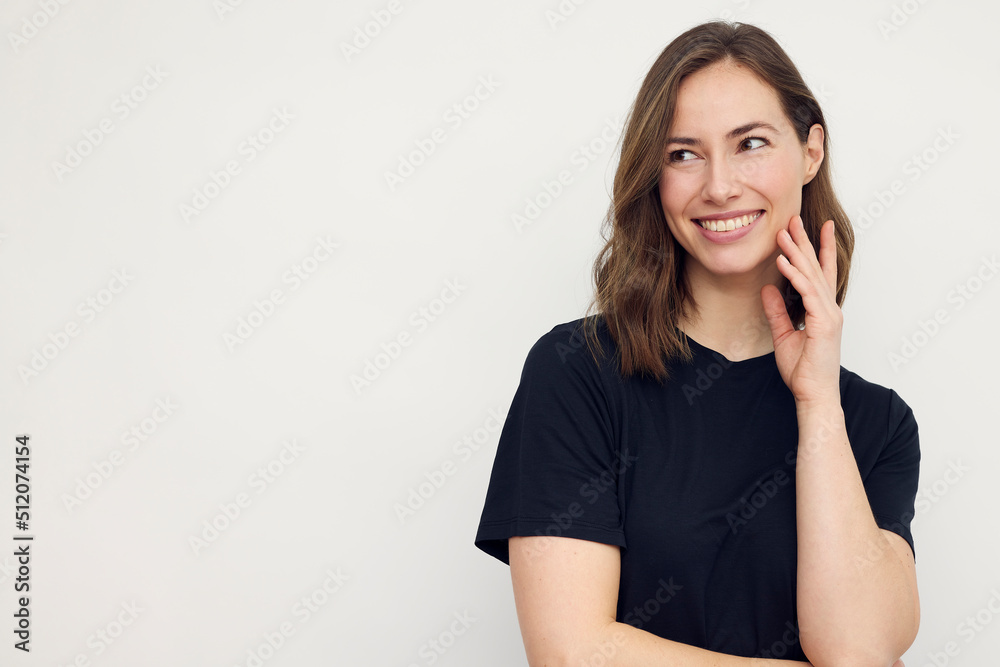 Portrait of young happy woman smiling on white background while looking to the left. Big smile on her face, looking beautiful and cute and with copyspace. Portrait of young happy woman smiling on white background while looking to the left. Big smile on her face, looking beautiful and cute and with copyspace.