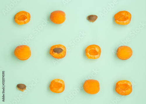 Ripe apricots pattern on green, pastel background. Top view. Summer concept.