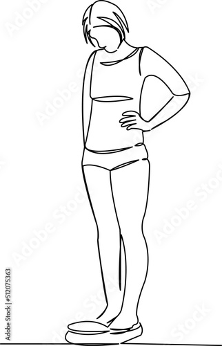 girl weighing herself on the scales